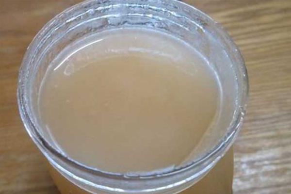 正宗椴树蜜的外观，呈水白色透明粘稠状、具有油脂光泽